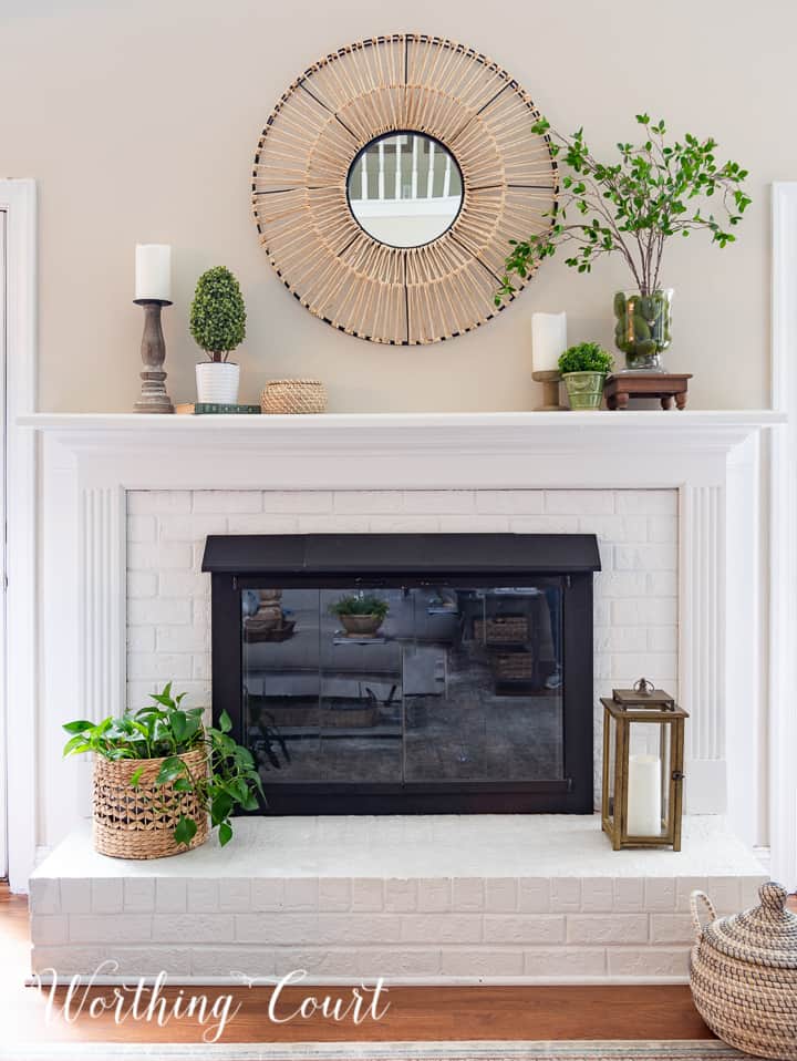 white painted brick fireplace with summer decor