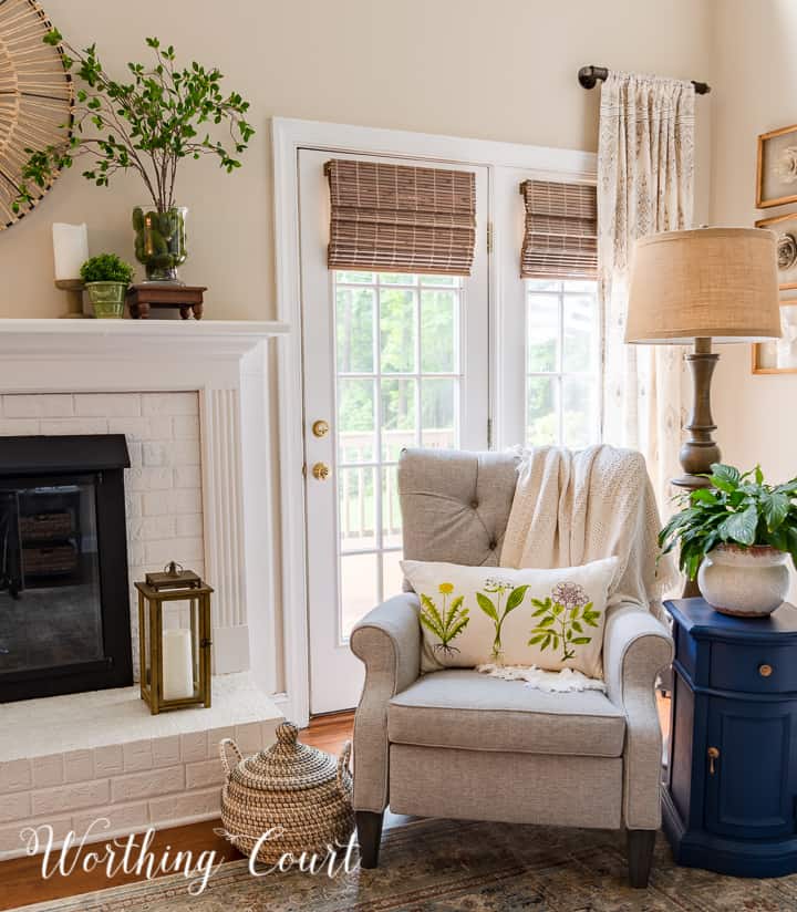 gray tufted recliner beside white brick fireplace