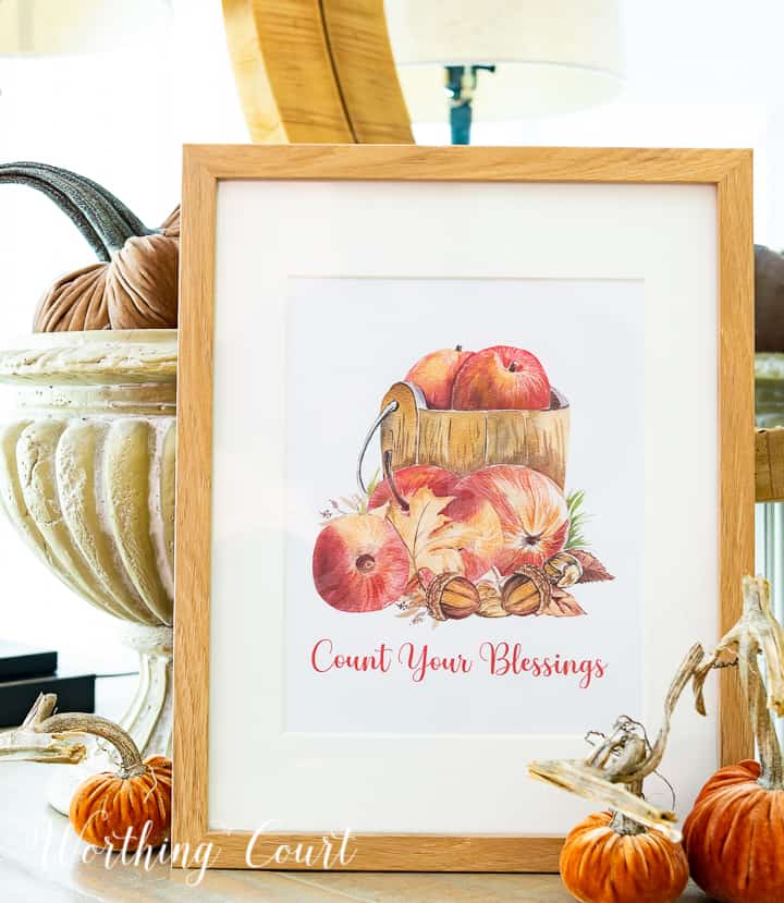 Graphic image of apples in a wood bucket with count your blessings wording below