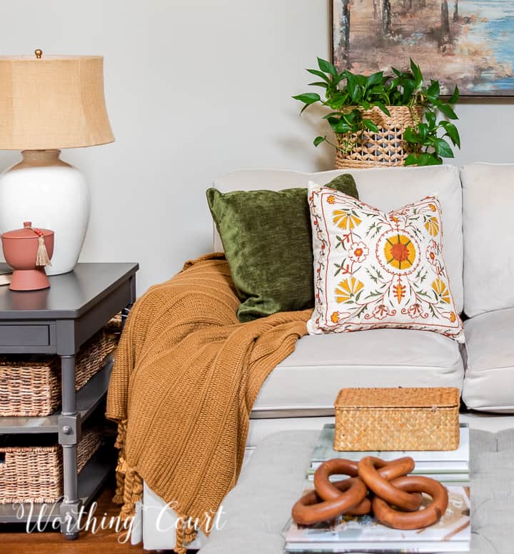 fall pillows and throw blanket on a neutral colored couch