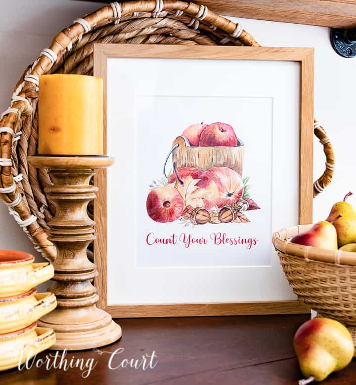Graphic image of apples in a wood bucket with count your blessings wording below