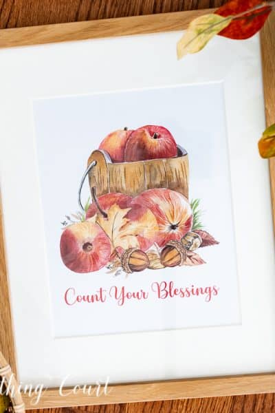 Graphic image of apples in a wood bucket with count your blessings wording below