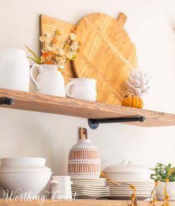 open wood shelves with white and wood fall decor