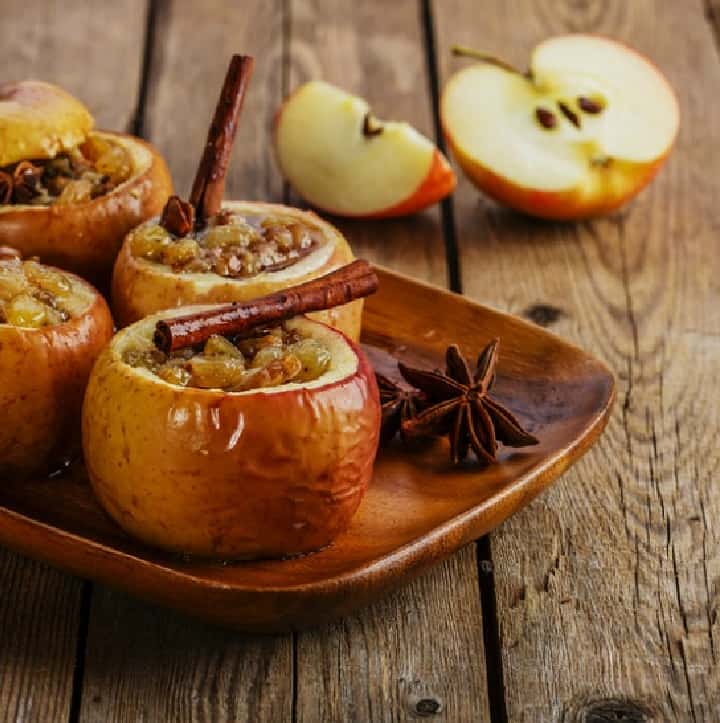 baked apples on a wood serving tray