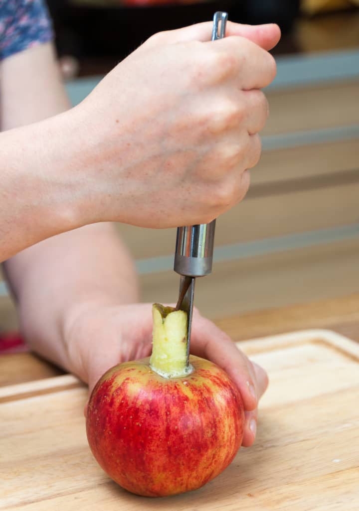 person coring and apple for a baked apple recipe