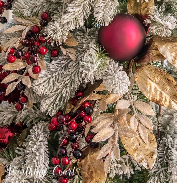 gold and burgundy decorations on a Christmas tree