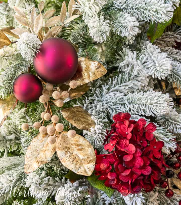 gold and burgundy decorations on a Christmas tree