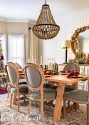 dining room decorated for Christmas with burgundy and gold decor