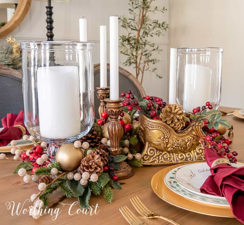 gold and burgundy Christmas centerpieces with glass hurricanes