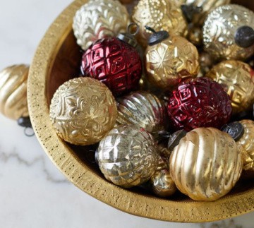 bowl of burgundy gold and silver Christmas ornaments