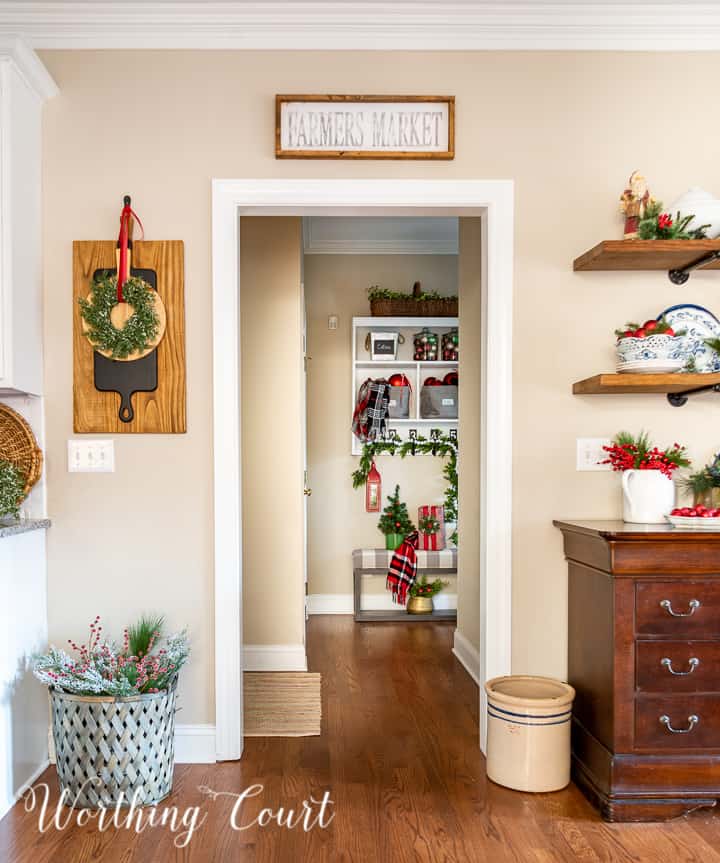 view looking through kitchen into drop zone area decorated for Christmas with traditional decor