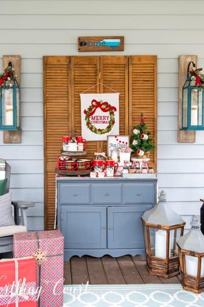 hot chocolate bar set up on a screen porch on a gray chest