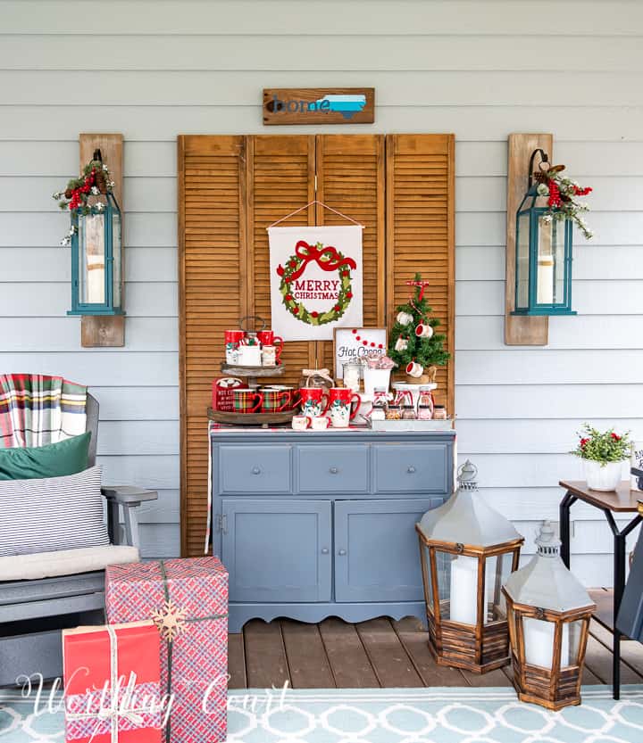 hot chocolate bar set up on a screen porch on a gray chest