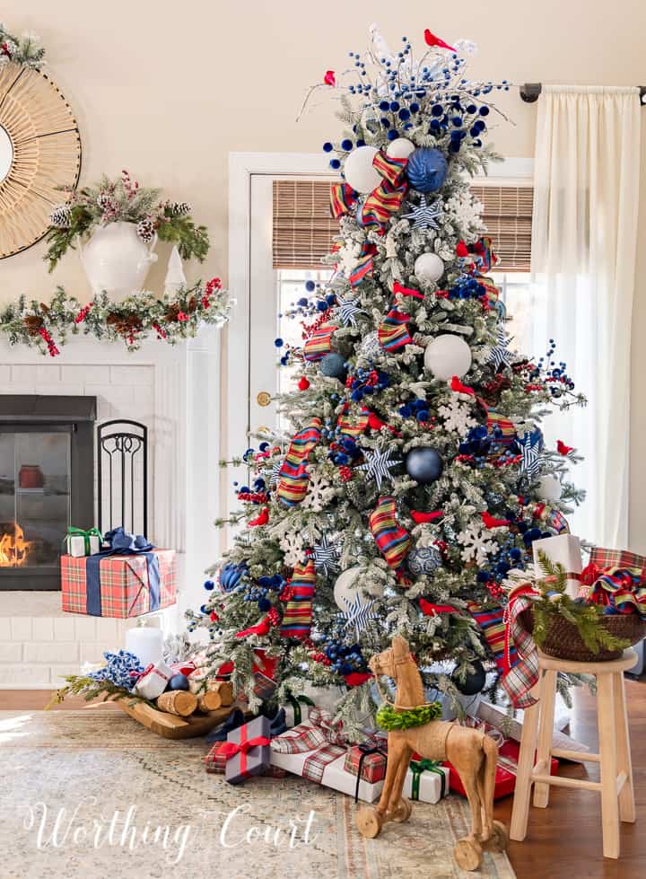 blue white and red decorations on a flocked Christmas tree