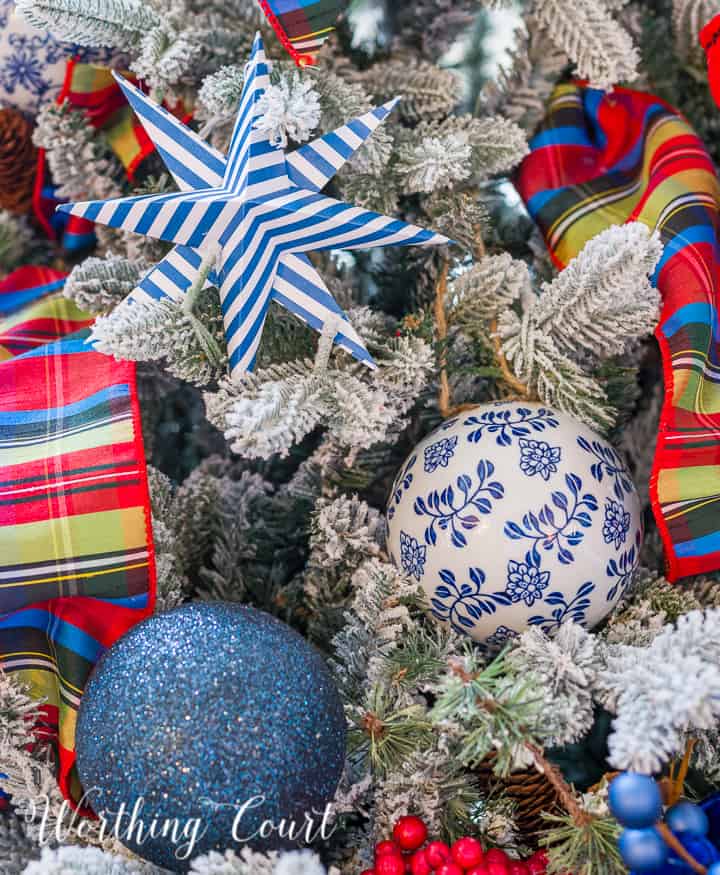 blue white and red decorations on a flocked Christmas tree