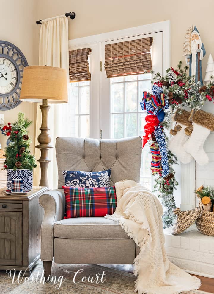 neutral colored recliner in front on windows surrounded with blue and red Christmas decor