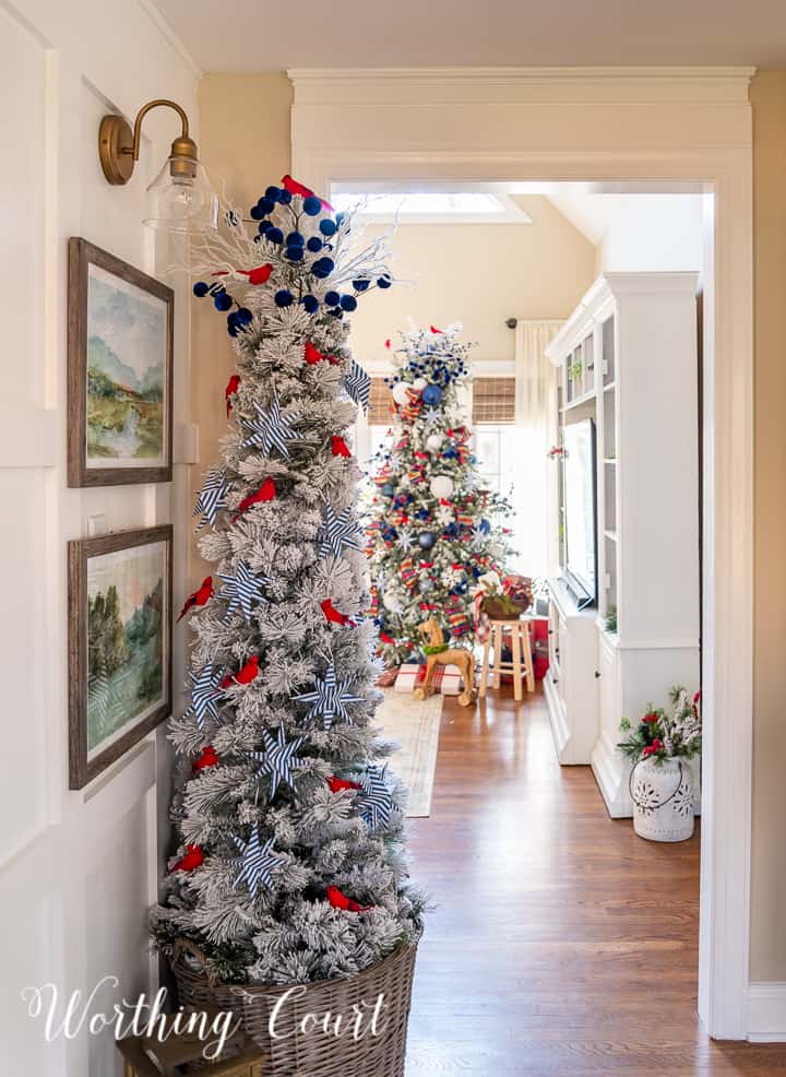 view through foyer of 2 Christmas trees