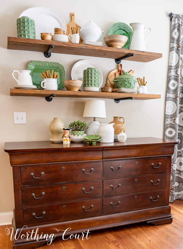 open wood shelves decorated with green, white and natural wood accessories