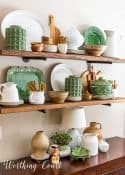 open wood shelves decorated with green, white and natural wood accessories