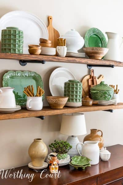 open wood shelves decorated with green, white and natural wood accessories