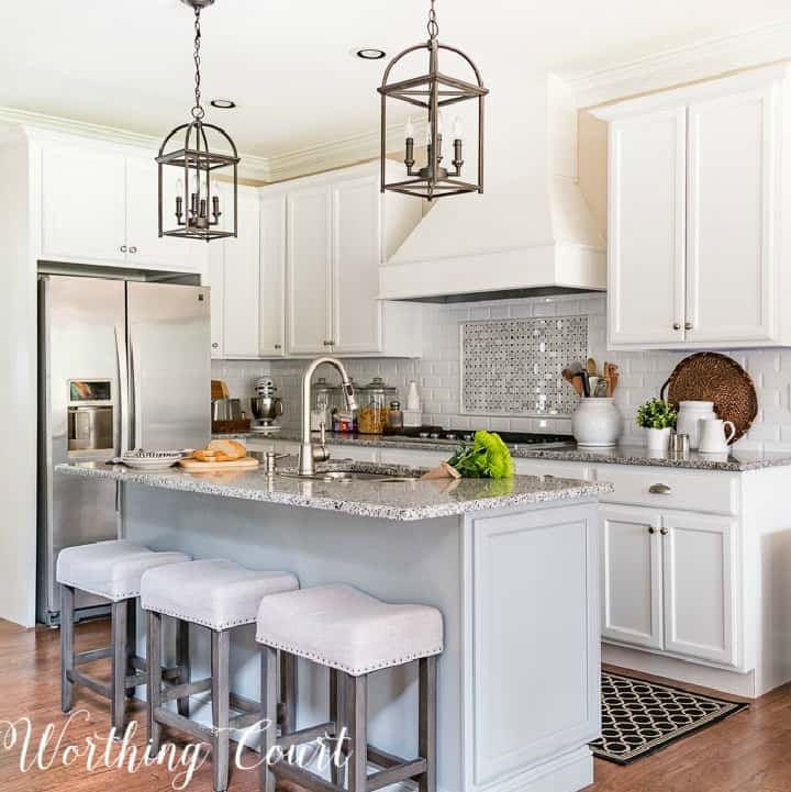 kitchen with gray island and white cabinets