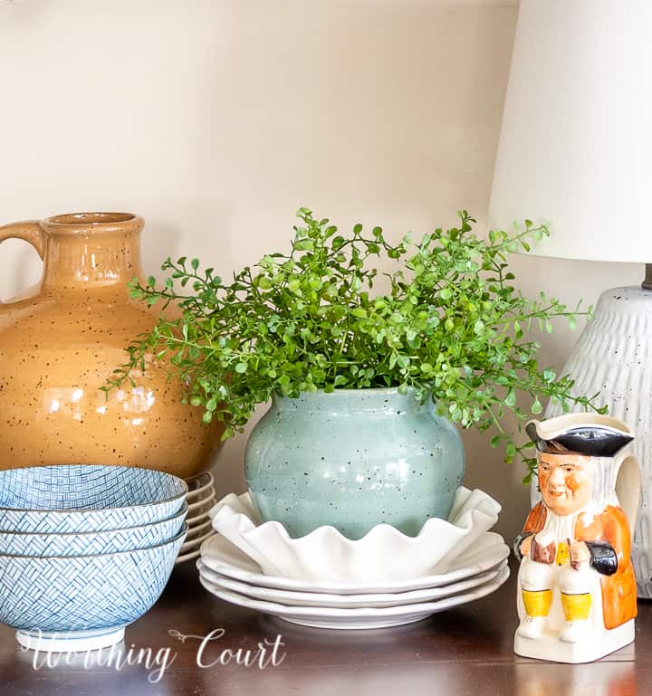 cottage style spring vignette on a sideboard