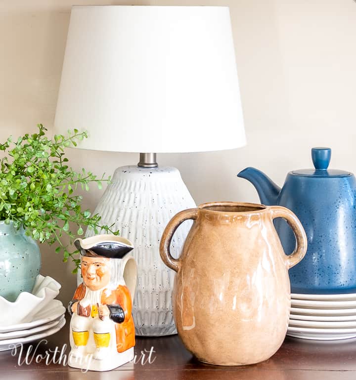 sideboard vignette with small lamp and blue and white accessories