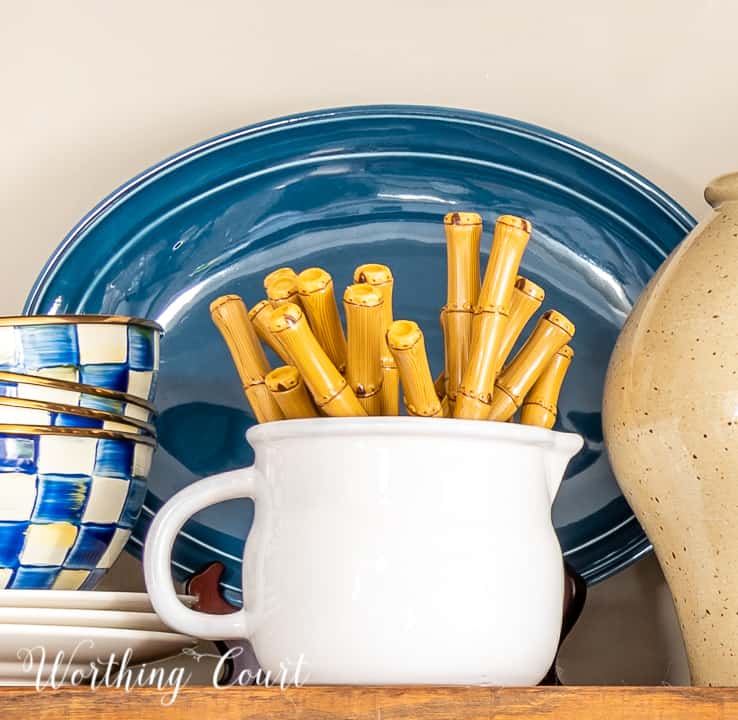 blue and white accessories on open wood shelf