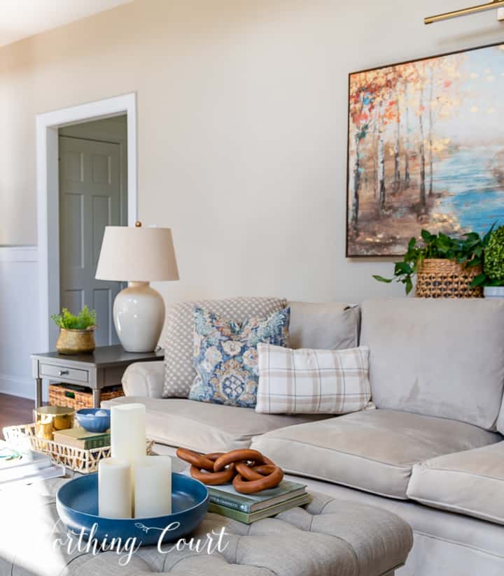 neutral colored couch in a living room with blue and white pillow assortment