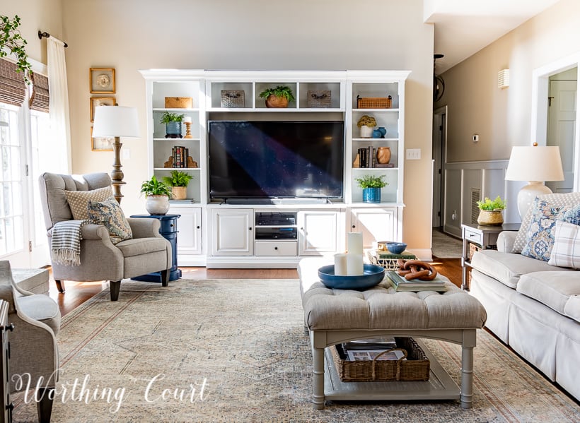 living room with white entertainment center, coffee table and blue and white accessories