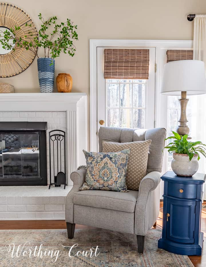 gray recliner beside white fireplace with blue and white spring decorations