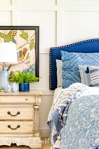 blue and white bedding and upholstered headboard