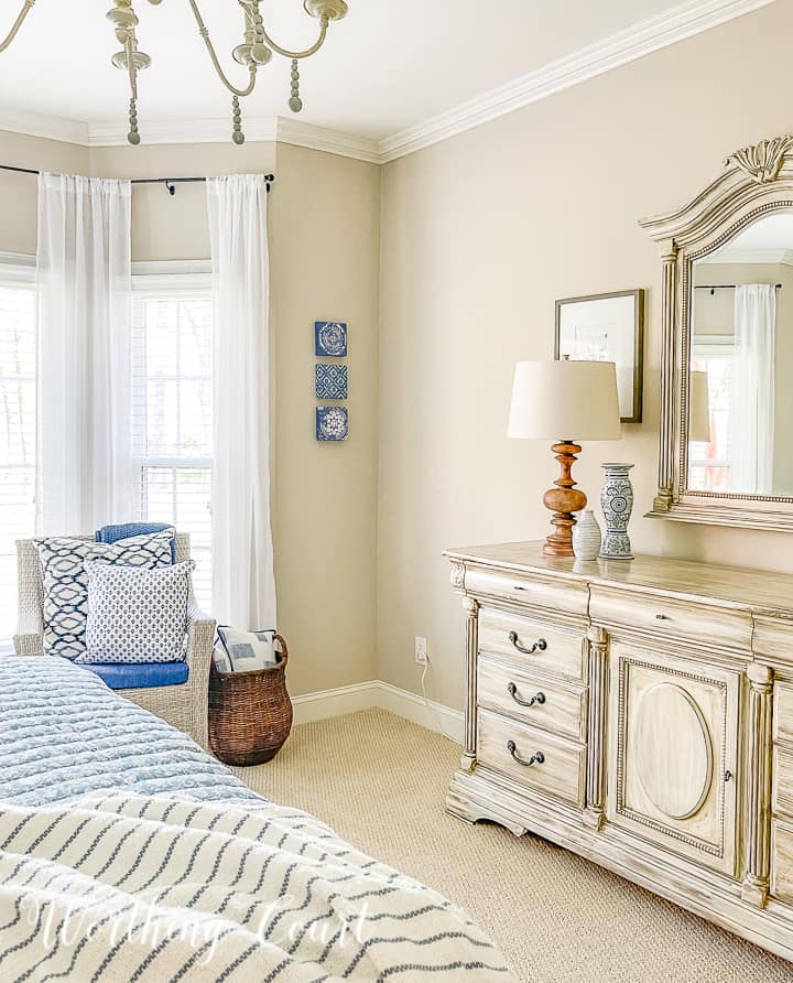 white chest of drawers and mirror with blue and white accessories