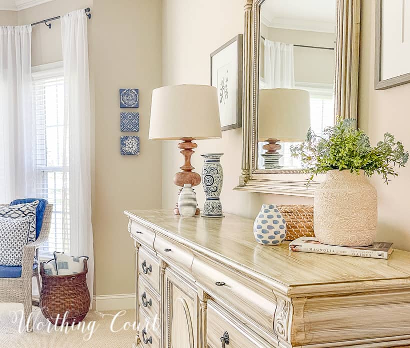 white chest of drawers and mirror with blue and white accessories