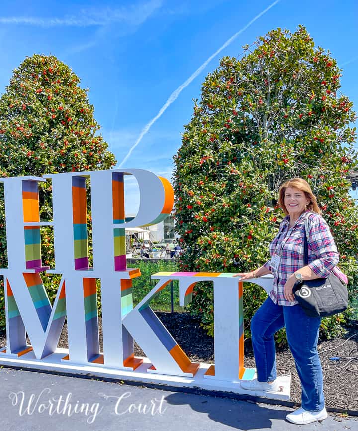 woman in front of a sign