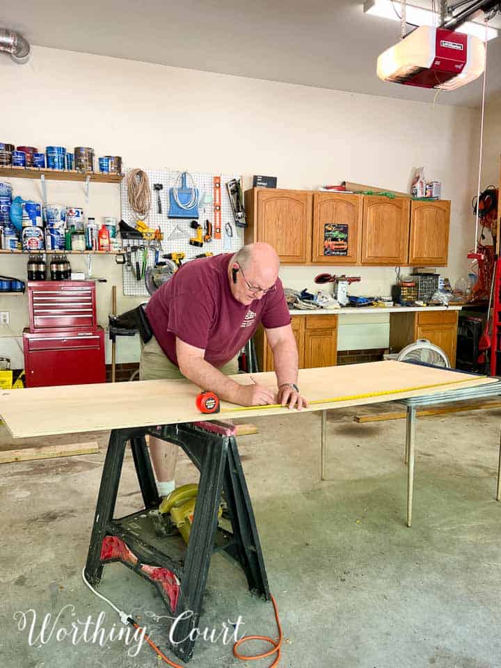 man working a piece of plywood