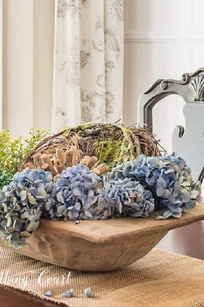 dough bowl filled with blue hydrangeas