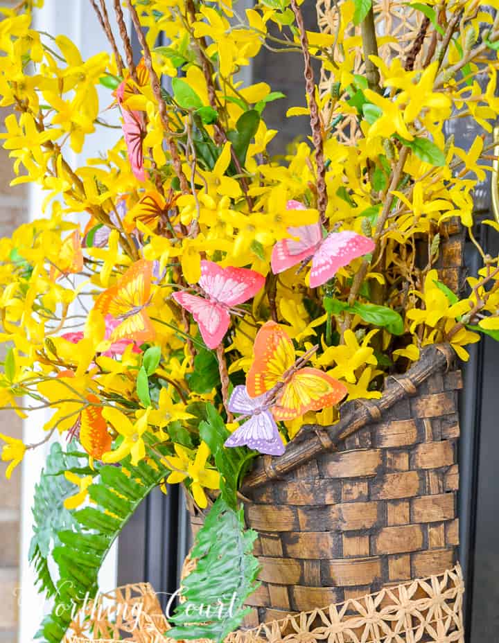 hanging basket filled with yellow flowers and greenery