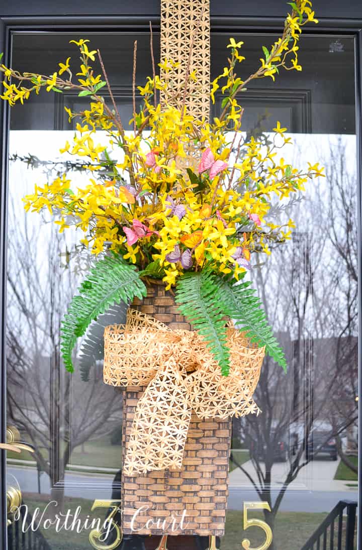 hanging basket filled with yellow flowers and greenery