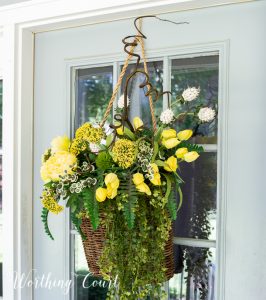 hanging basket filled with yellow flowers and greenery