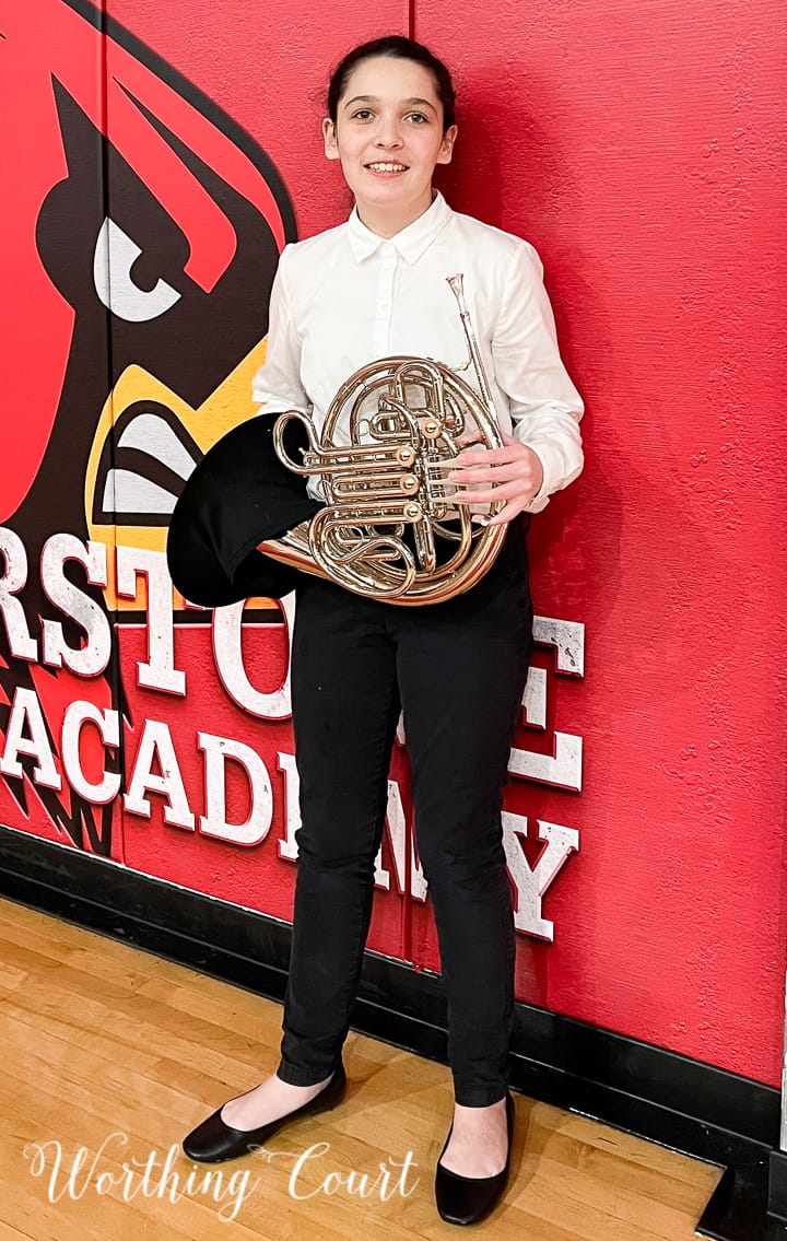 teenage girl holding a french horn