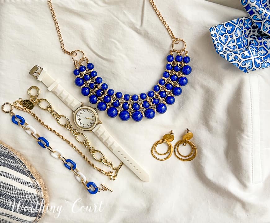 image of blue and gold jewelry lying on a white background