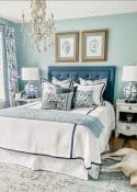 blue upholstered headboard with blue and white linens
