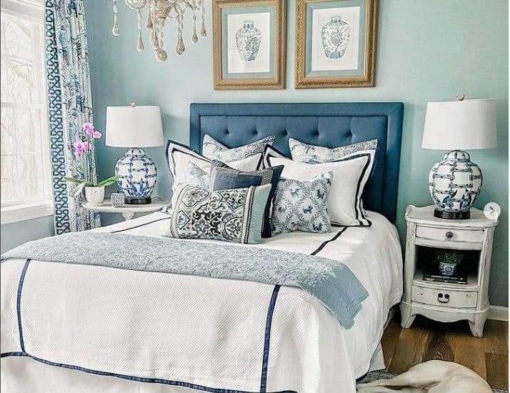 blue upholstered headboard with blue and white linens