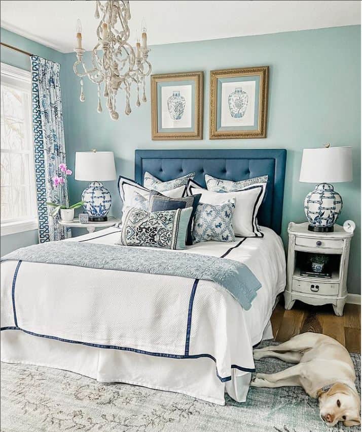 blue upholstered headboard with blue and white linens