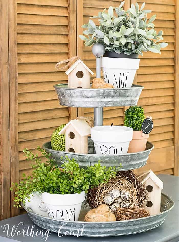 a metal tiered tray decorated for spring