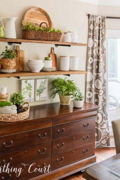 decorated open shelves above a sideboard
