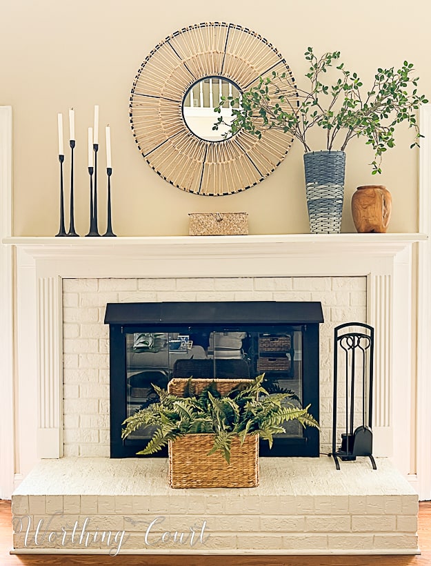 white brick fireplace decorated for summer