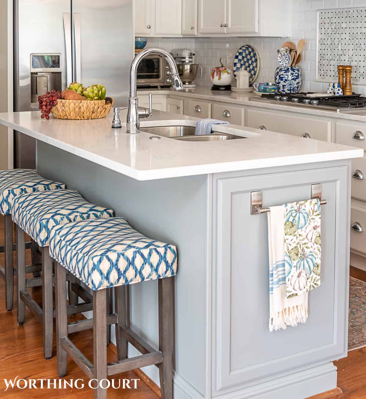 fall kitchen decor on a gray island with three counter height stools