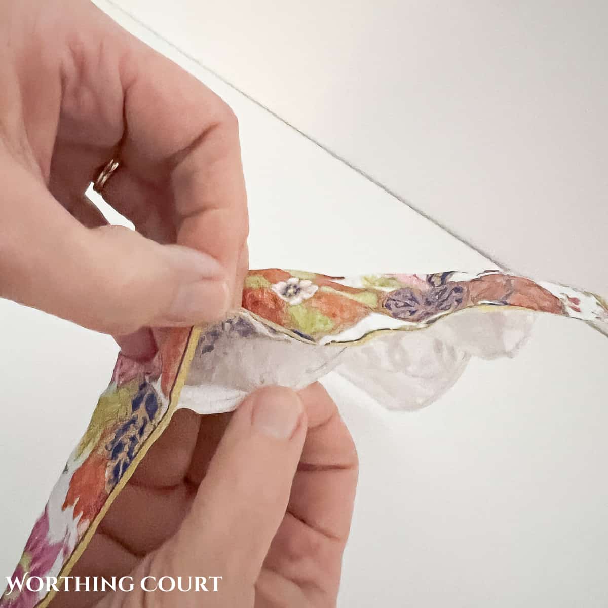 image of pulling the layers of a napkin apart to decoupage on a pumpkin